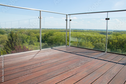 Contemporary architecture apartment balcony view with exotic cumaru wood grooved decking and glass railing