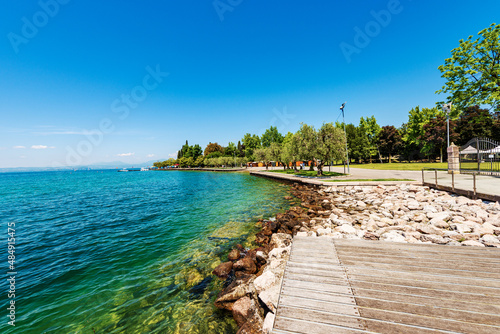 Wallpaper Mural Lakefront of the small Bardolino village with the pedestrian and bicycle lane. Tourist resort on the coast of Lake Garda. Verona province, Veneto, Italy, southern Europe. On horizon the Lombardy coast Torontodigital.ca