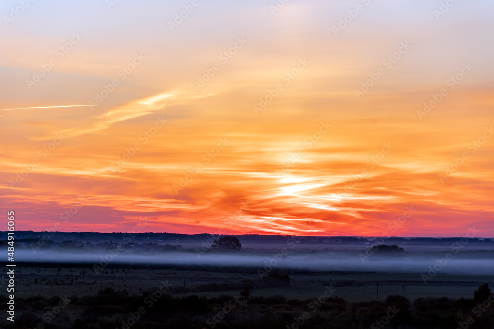 The heavenly light of the sun.Dramatic evening sky with clouds and rays of the sun.Sunlight at evening sunset or morning sunrise.Panoramic view of cirrus clouds in motion.Golden ray of the sun.Weather