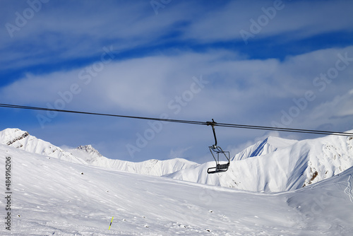 Chair lift and off-piste slope at nice day