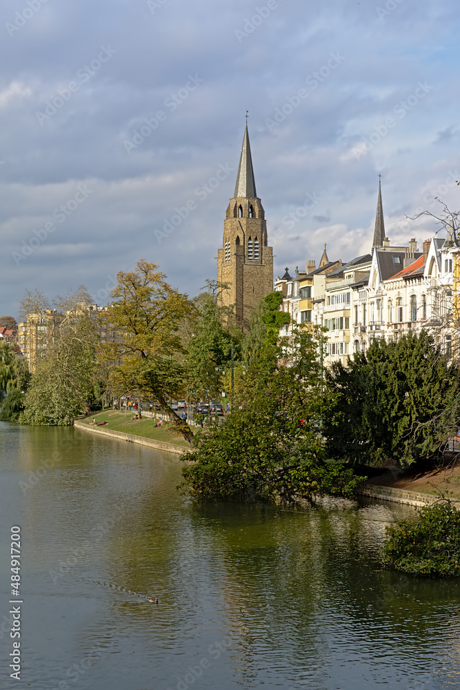 Church of the holy cross, reflecting in the water of Ixelles lakes