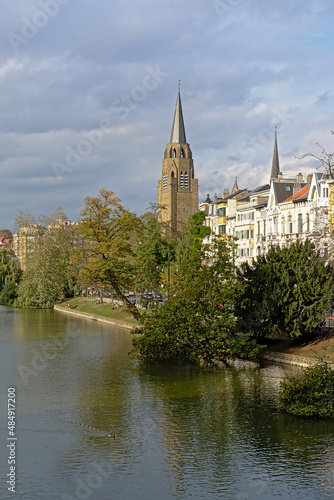 Church of the holy cross, reflecting in the water of Ixelles lakes