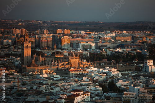 Sunset in the city of Seville. Cathedral of Seville gothic style and Giralda. © CristianGali