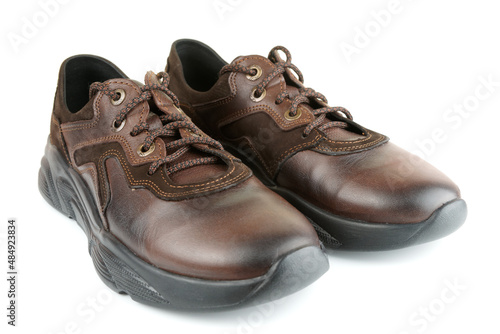 Brown leather walking shoes on white
