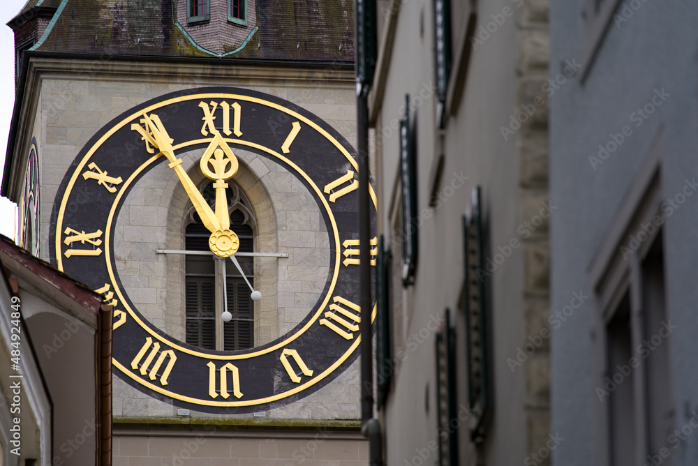 Protestant clock tower of church St. Peter with gray sky background on a winter day. Photo taken February 1st, 2022, Zurich, Switzerland. Protestant clock tower of church St. Peter with gray sky background on a winter day. Photo taken February 1st, 2022, Zurich, Switzerland.