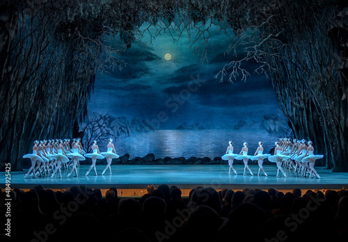 Classical ballet on stage of Theater. Ballet dancers on stage dance classical works. Form of artistic ball dance on stage of theater.