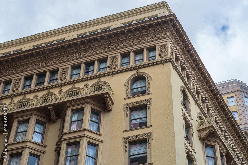 Corner of building in downtown showing elaborate architectural details in New Orleans, LA, USA