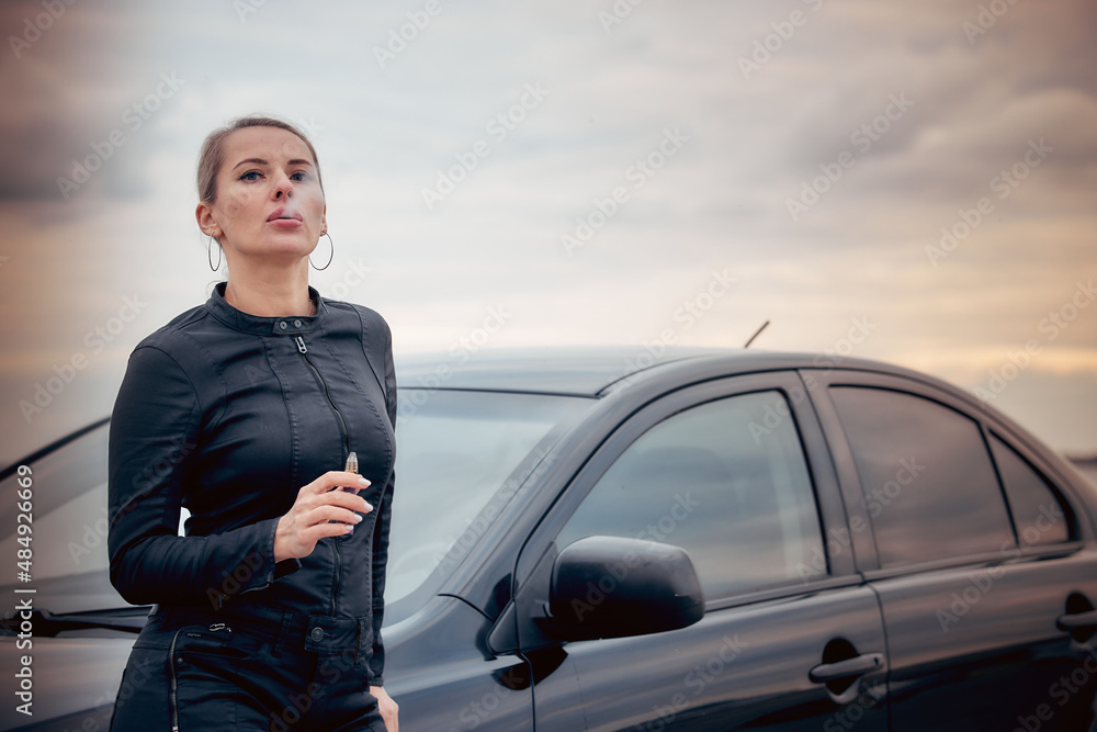 blonde woman smokes vape with pleasure blonde woman smokes vape with pleasure