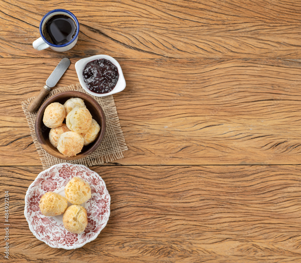 Fototapeta premium Typical brazilian cheese bun on a plate, coffee, jam and copy space