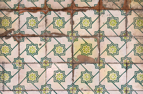 old damaged tiles in Portugal, grenen and white color, photography takes in buildings of Portugal photo