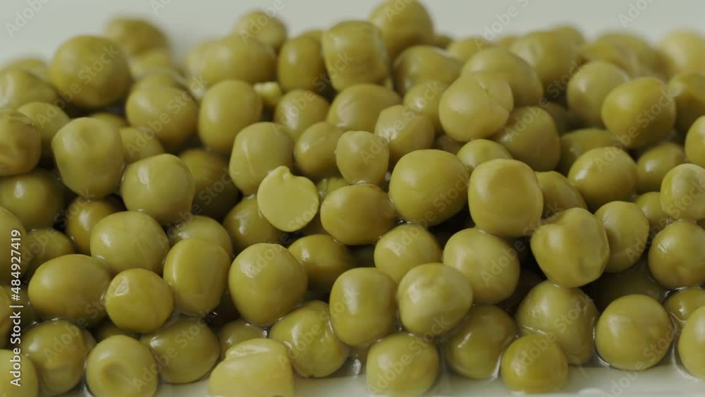 White bowl with canned green peas. Fermented food White bowl with canned green peas. Fermented food