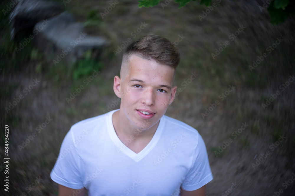 Portrait of a teenager on the background of nature. View from above. Natural skin of the face, without retouching. Portrait of a teenager on the background of nature. View from above. Natural skin of the face, without retouching.