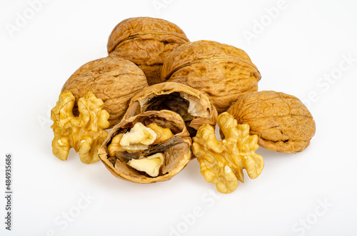 Unpeeled ripe walnuts on white background. Studio Photo