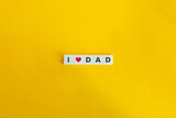 I Love Dad Banner. Letter tiles on bright orange background. Minimal aesthetics.