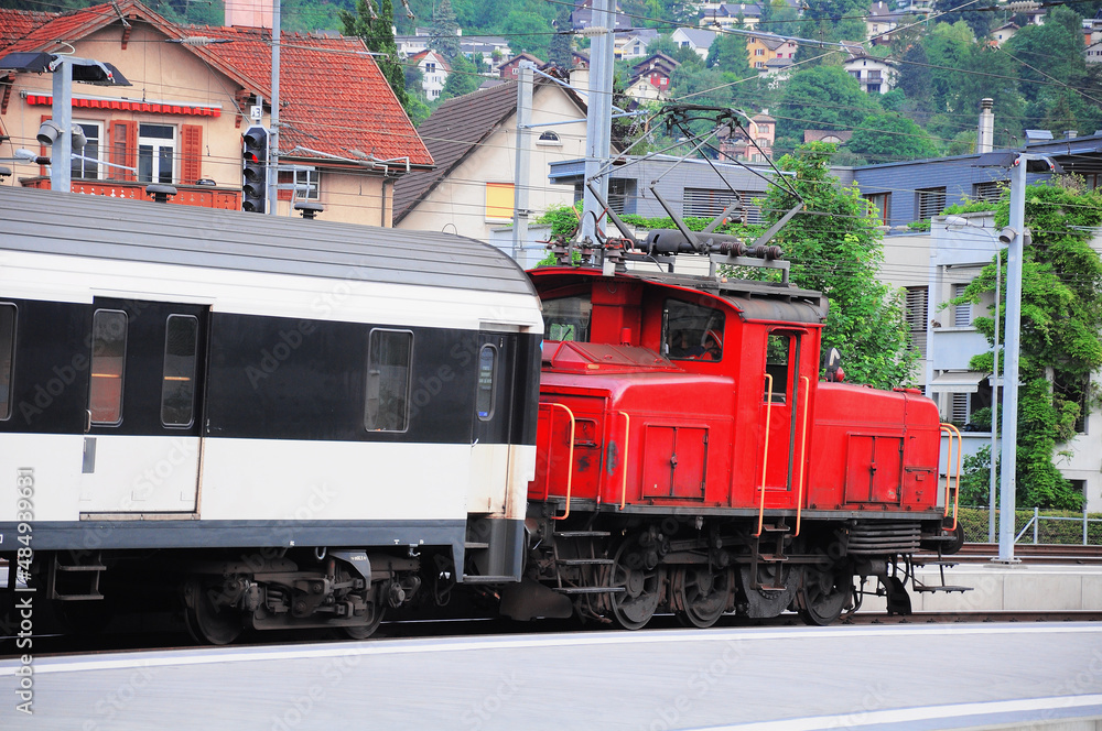 Naklejka premium Passenger train arrives to the platform. Chur.