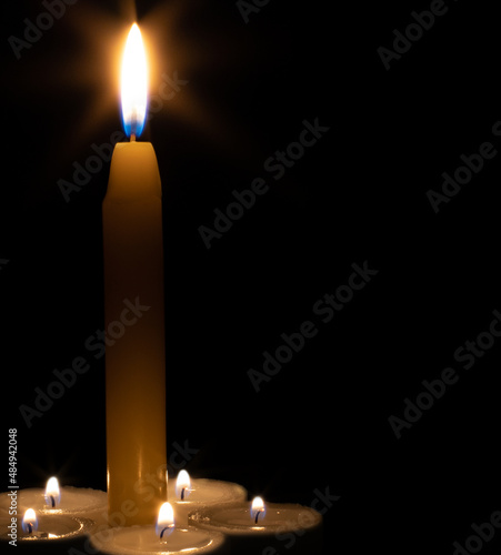 burning candles on a dark background. flame with a halo.