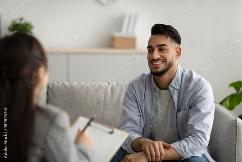 Effective psychotherapy. Happy middle eastern man talking to his psychologist, sharing therapy results with counselor