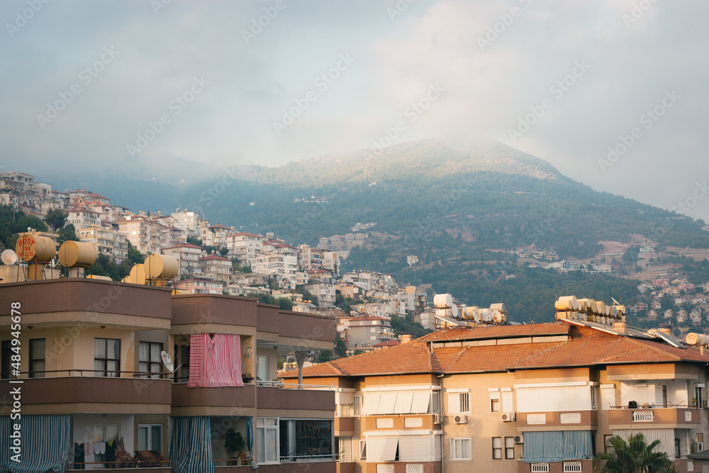 Lots of houses spread on the mountain. Heavy clouds, fog, storm is comming. Turkey, Alanya