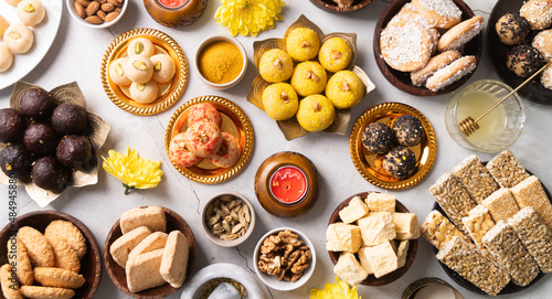 Fényképezés traditional indian sweets on concrete background flat lay