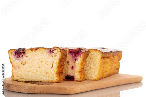 Several slices of homemade cottage cheese casserole with cherries on a wooden tray, macro, isolated on a white background.

