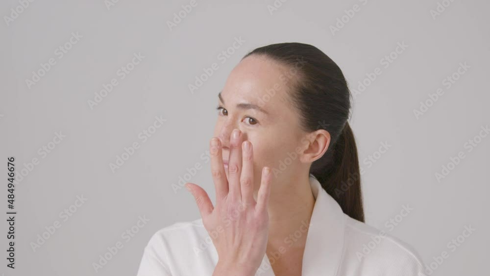 Tracking Shot of Young Woman Blending Concealer and Smiling Tracking Shot of Young Woman Blending Concealer and Smiling