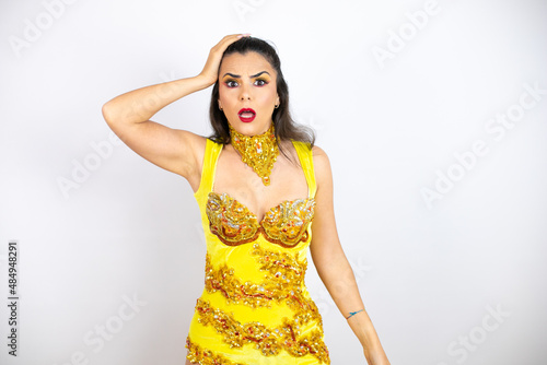 Young beautiful woman wearing carnival costume over isolated white background putting one hand on her head smiling like she had forgotten something