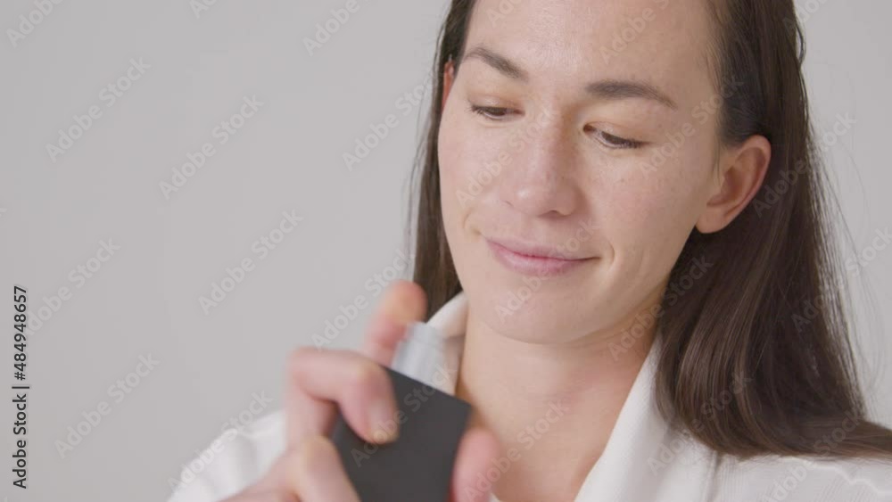 Close Up Shot of Woman Smiling and Spraying on Perfume Close Up Shot of Woman Smiling and Spraying on Perfume