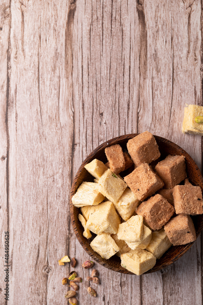 soan papdi, son rolls, patisa on a rustic background soan papdi, son rolls, patisa on a rustic background