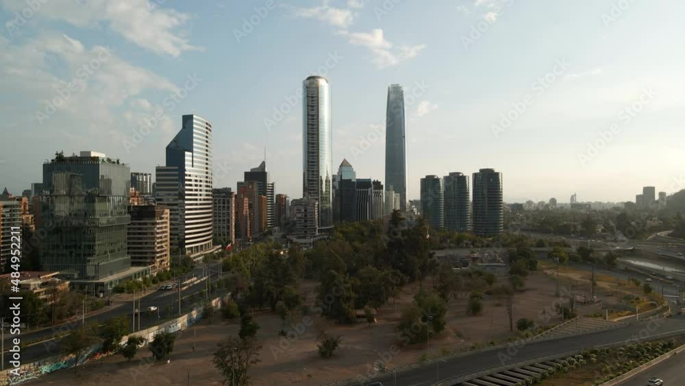Aerial dolly in of park next to modern Sanhattan skyline skyscrapers at daytime, Santiago, Chile Aerial dolly in of park next to modern Sanhattan skyline skyscrapers at daytime, Santiago, Chile