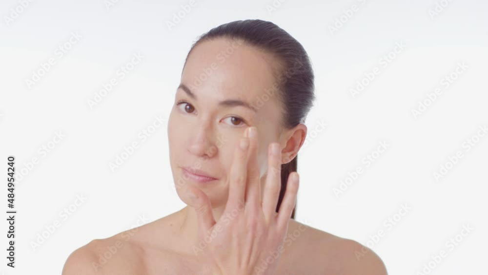 Mid Shot of Young Woman Blending Concealer with Finger Mid Shot of Young Woman Blending Concealer with Finger