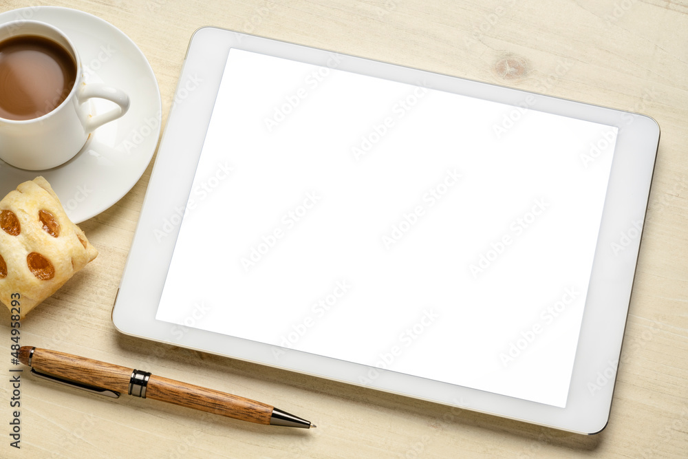 mockup of digital tablet with a blank isolated screen (clipping path included), flat lay with a cup of coffee and cookie on wooden table mockup of digital tablet with a blank isolated screen (clipping path included), flat lay with a cup of coffee and cookie on wooden table