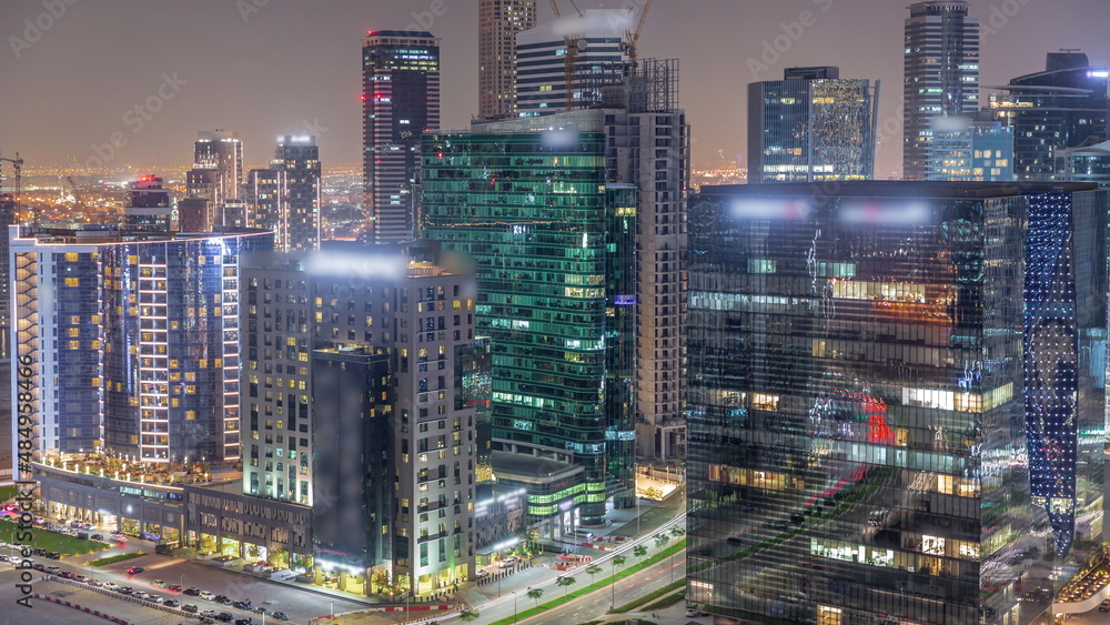 Business Bay Dubai skyscrapers with city lights reflected on glass aerial night timelapse. Business Bay Dubai skyscrapers with city lights reflected on glass aerial night timelapse.