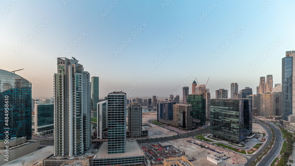 Business Bay Dubai skyscrapers with water canal aerial timelapse.