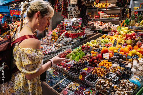 Photography Asian woman choosing fruits in market