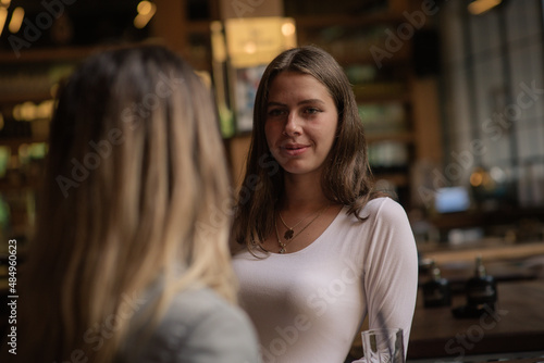 Smiling while looking and talking to her sister