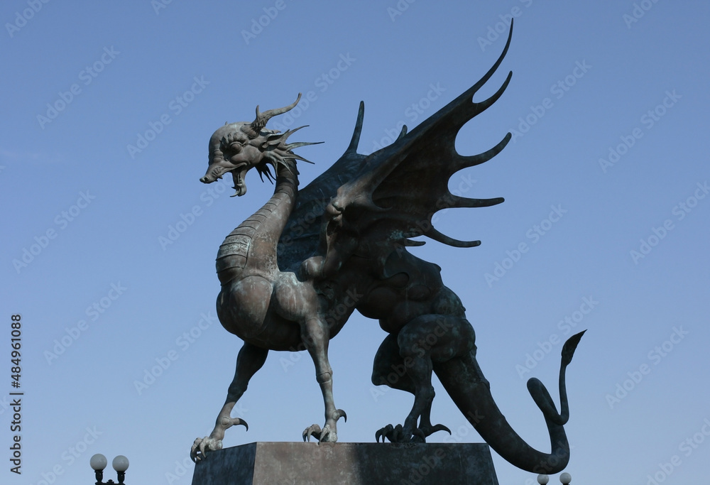 Fototapeta premium Kazan, Russia - July 13, 2021: Statues of Dragon Zilant at Kazan Wedding Palace (Family Center) at sunset, Tatarstan. It is landmark of Kazan. 