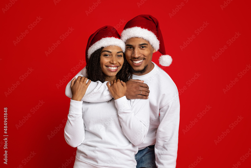 Handsome black man hugging his pretty wife Handsome black man hugging his pretty wife