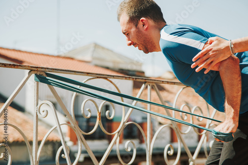 A couple doing training with rubber resistance band on their fooftop photo