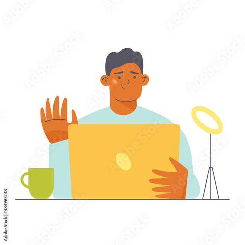 Young man with laptop sitting at the desk and waiving her hand. Flat character vector illustration.