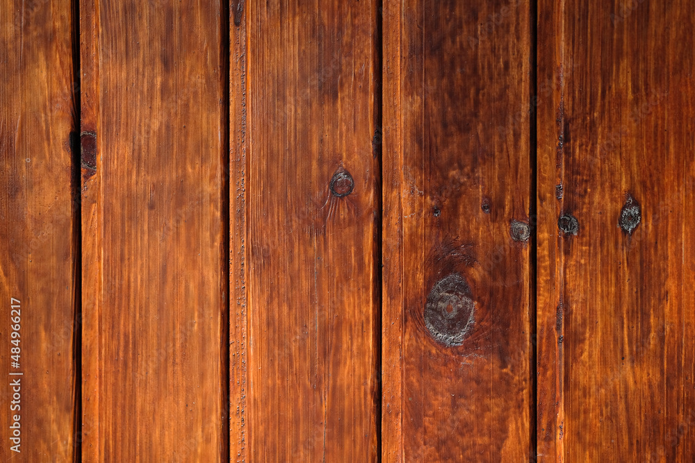 Brown wood background. Vertical planks of brown color close-up. Wood texture. Wooden brown boards background. Old fence boards at home. Rough board surface. Brown wood background. Vertical planks of brown color close-up. Wood texture. Wooden brown boards background. Old fence boards at home. Rough board surface.