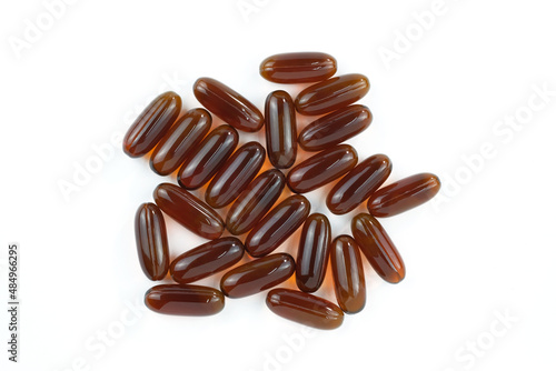 Sunflower lecithin in capsules on a white background. Lecithin in brown capsules top view. Food supplements close-up.