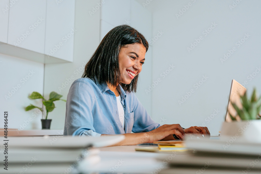Young business woman working using laptop sitting at the desk Young business woman working using laptop sitting at the desk