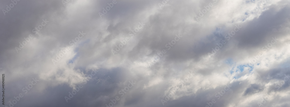 The sky is covered with dense gray clouds, panorama
