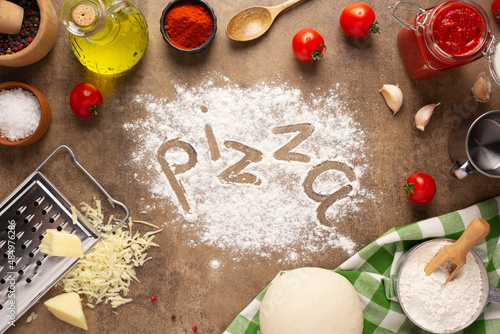 Pizza and flour homemade cooking or baking at table. Pizza ingredient on tabletop