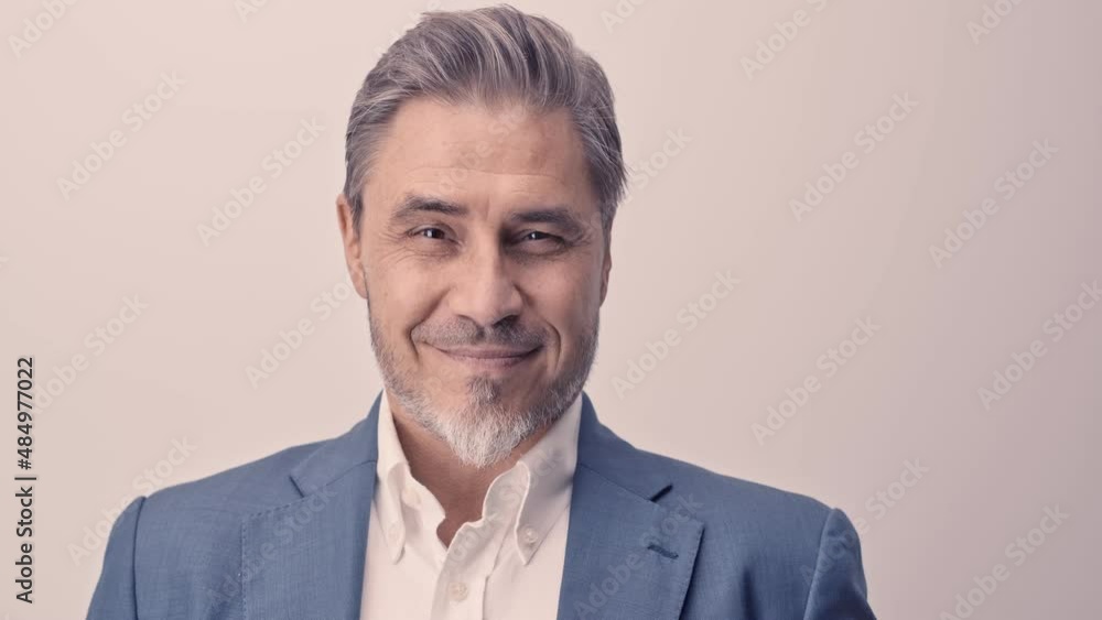 Business portrait - businessman smiling. Mature age, middle age, mid adult man in 50s with happy confident smile. Copy space.