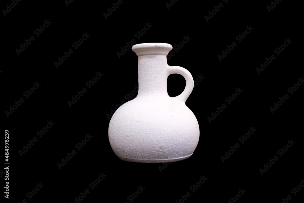 white plaster jug isolated on a black background white plaster jug isolated on a black background