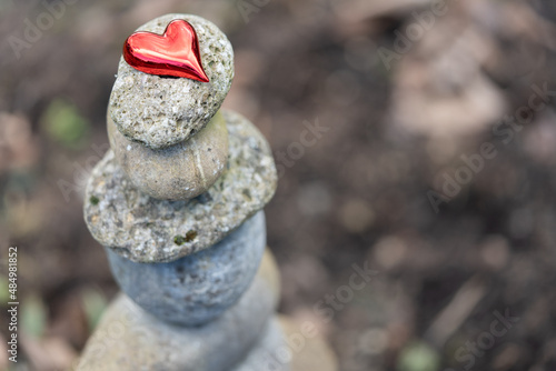 Canvas Print Selective focus on red heart on top of a stack of stone