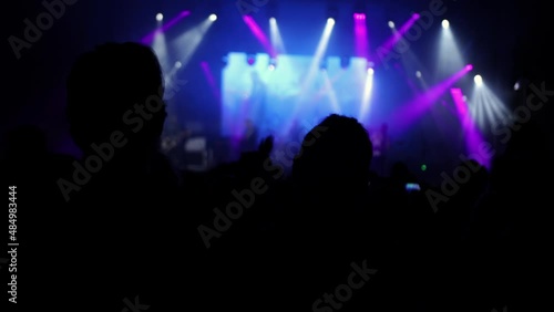 Wallpaper Mural Concert crowd silhouettes in front of bright stage lights. Silhouette of people raising their hand up in performance with rock star playing guitar on platform. Concert crowd silhouettes Torontodigital.ca