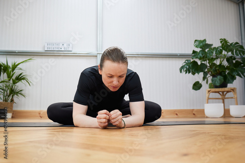 adult woman in black clothes practicing yoga