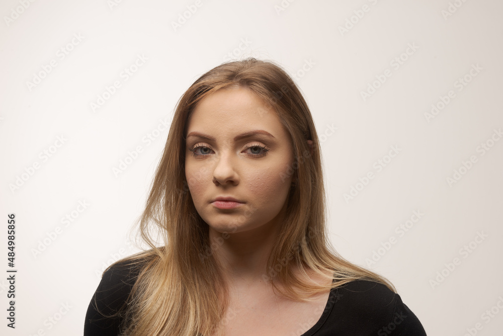 Fototapeta premium Angry young woman portrait in studio white background